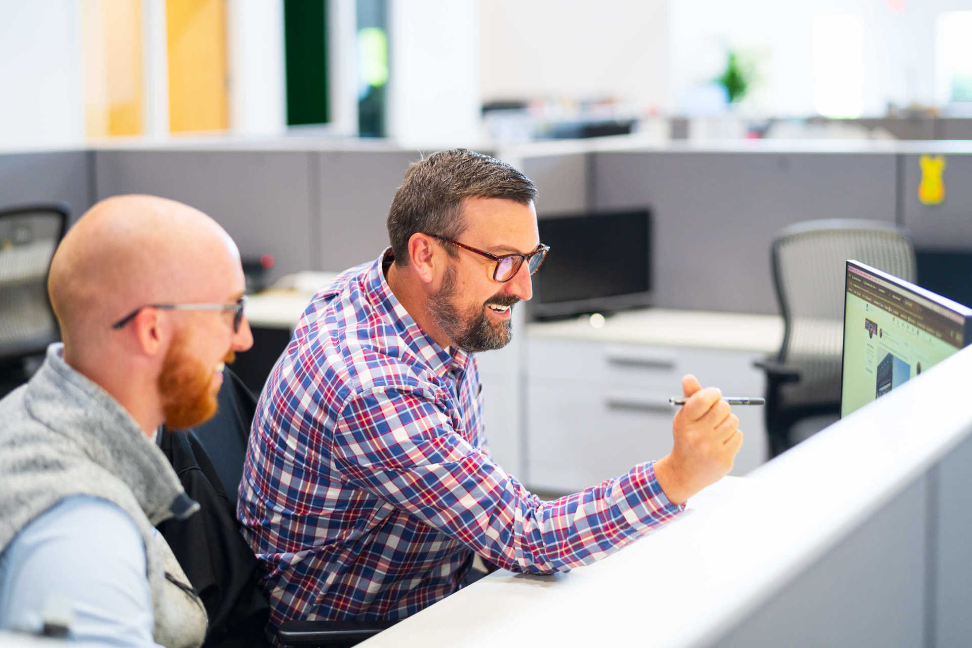 Two Stamm employees working together at a desk 