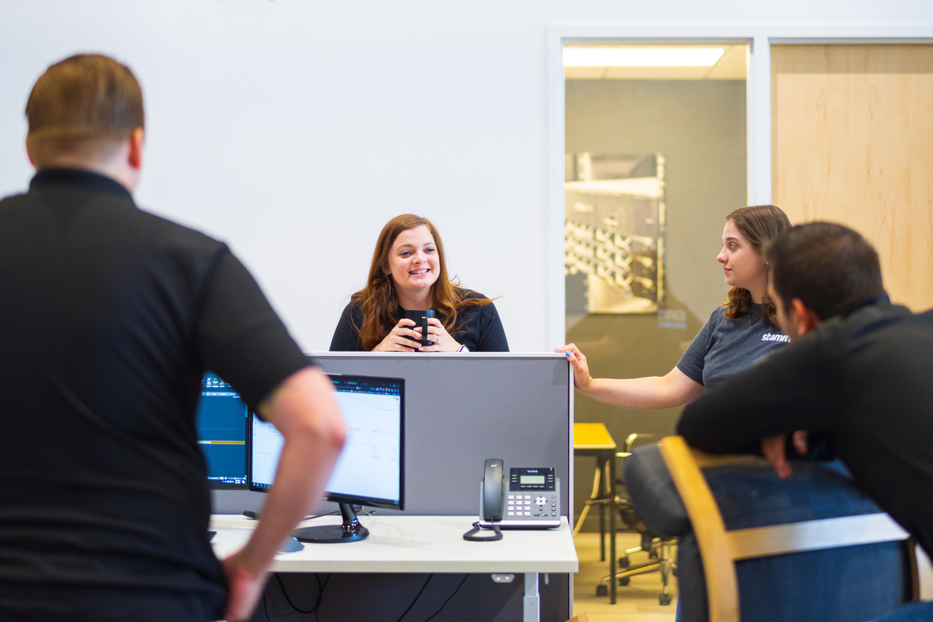 Stamm employees gathering in the office to collaborate
