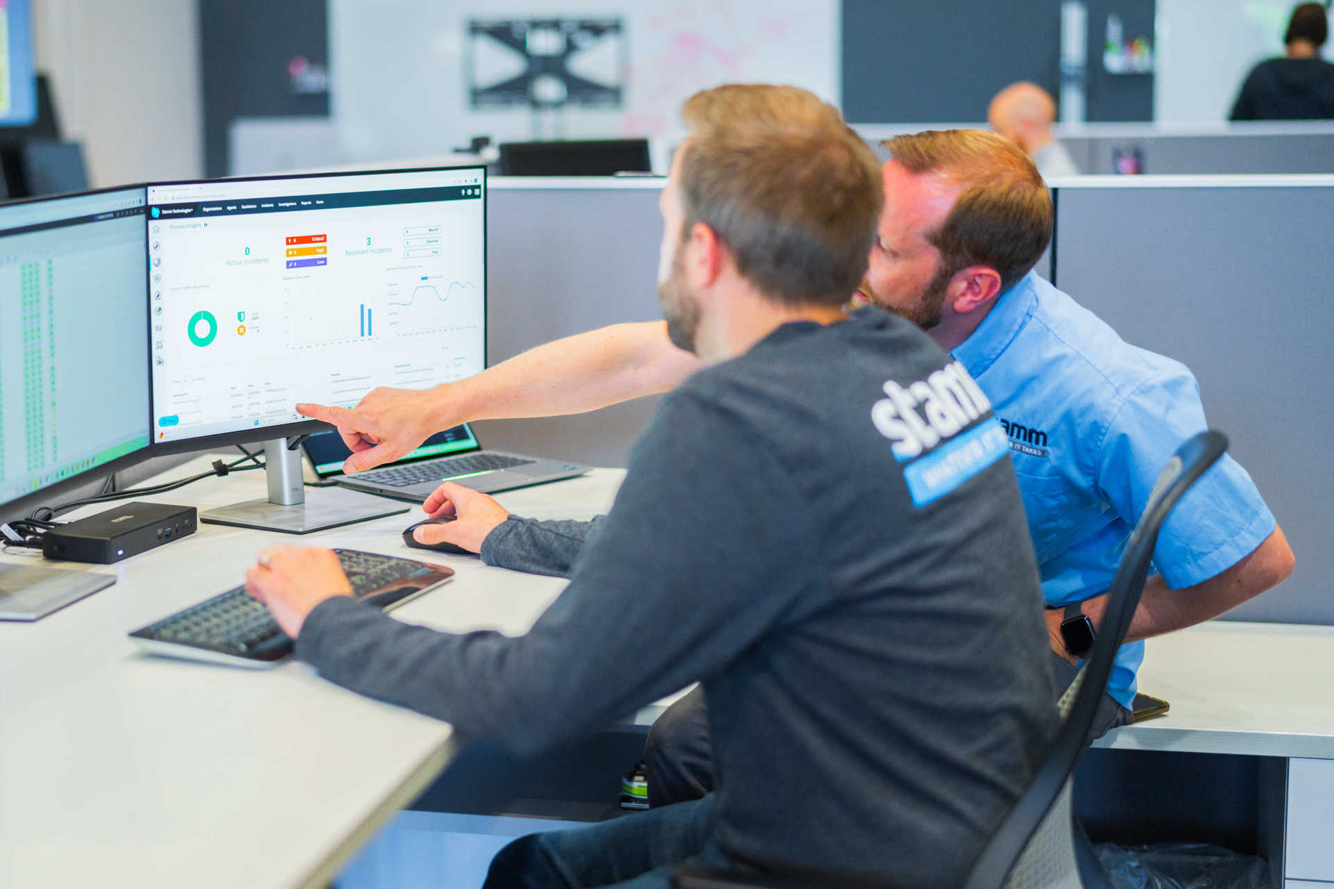 Two Stamm employees working together at a desk 